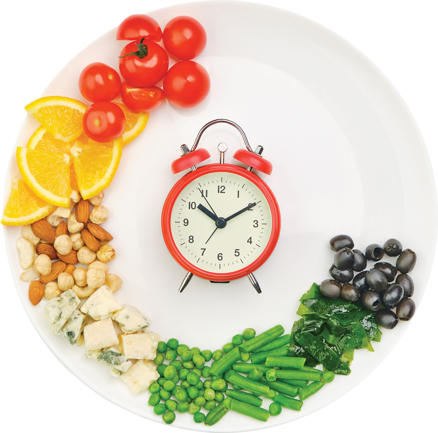 photo of a plate with various healthy foods arranged around the outer edge and a red alarm clock in the center