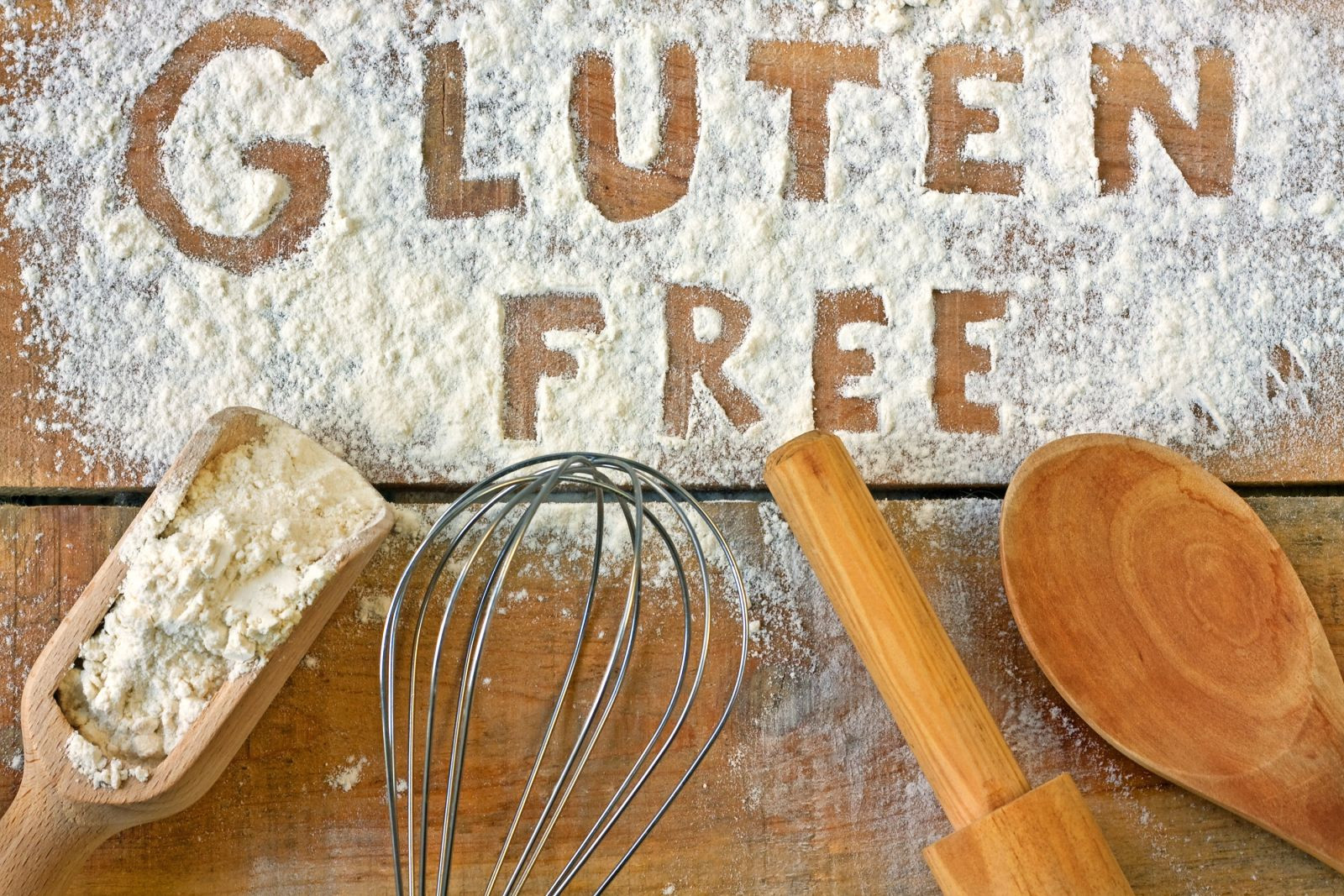 Baking utensils with the words "gluten free" written in flour. 