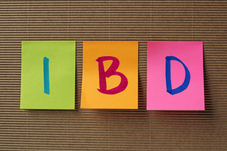 photo of brown corrugated cardboard with the letters IBD written on three sticky notes in different colors green orange pink