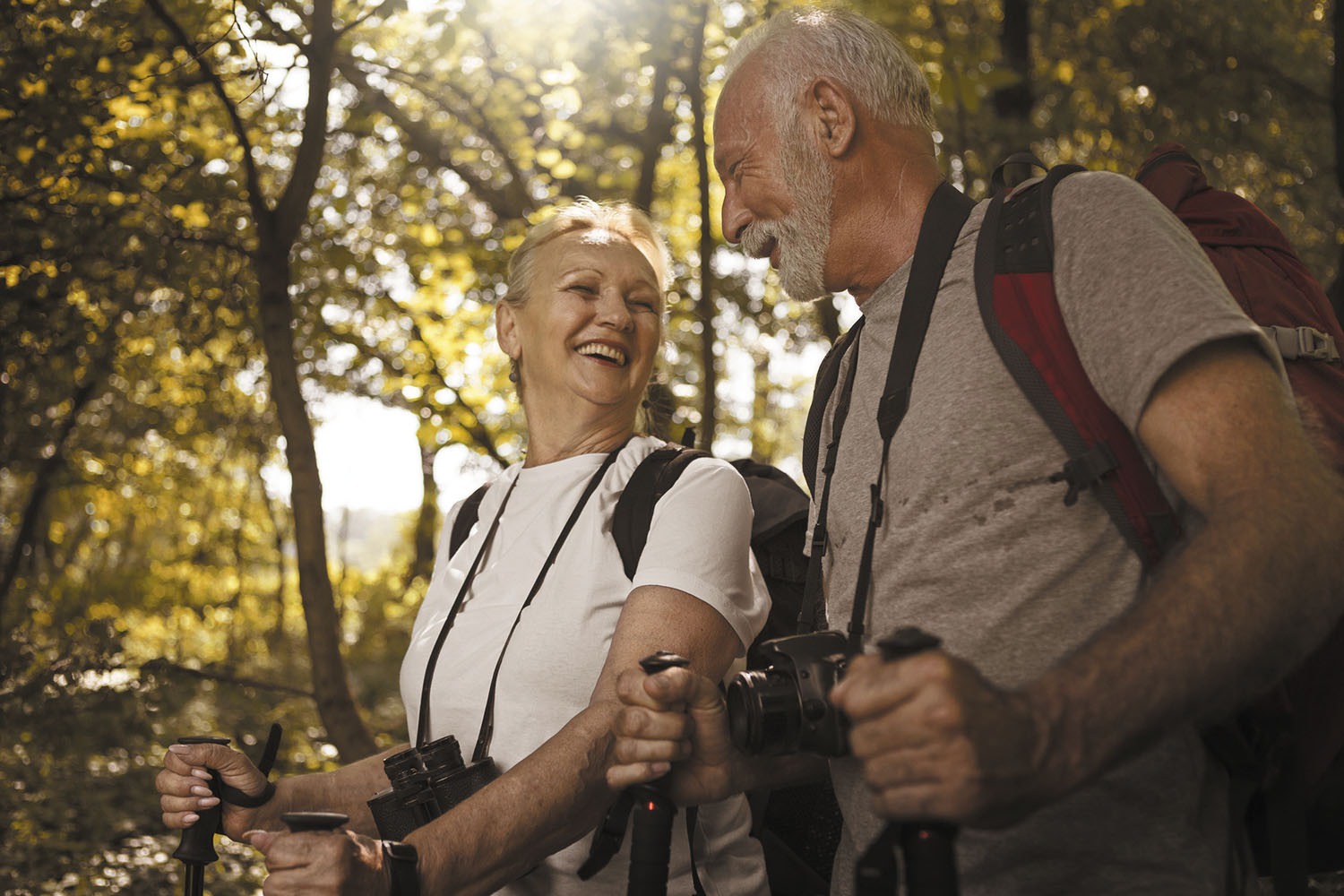 photo of a mature couple enjoying a hike in a wooded area