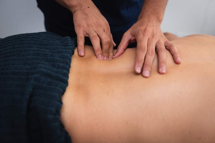 An image of a chiropractor treating a patient's back.