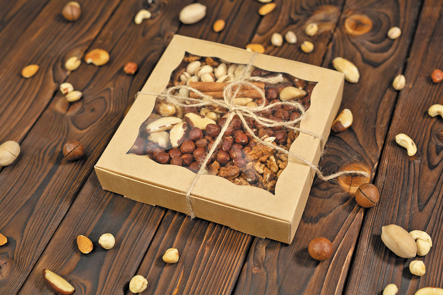 photo of a box of assorted roasted nuts tied with a string to be presented as a gift