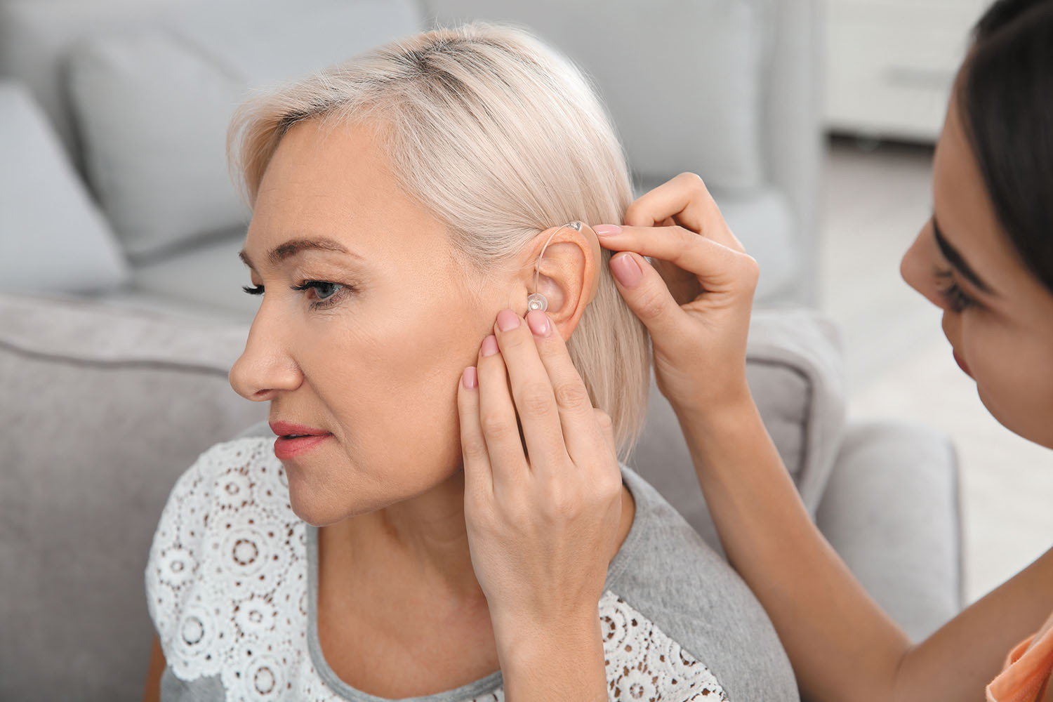 photo of a woman being fitted for a hearing aid