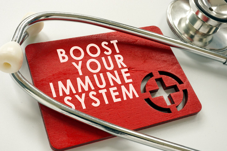 photo of a plastic placard reading boost your immune system with a stethoscope resting on top of it
