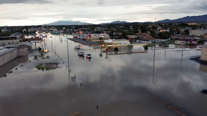 Aerial view of a city in Texas with flooding in  streets and buildings in the foreground