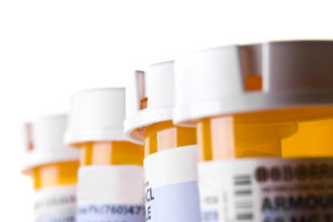 A line of 4 prescription pill bottles