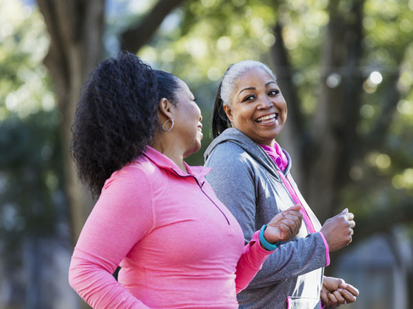 Two smiling women on a run together