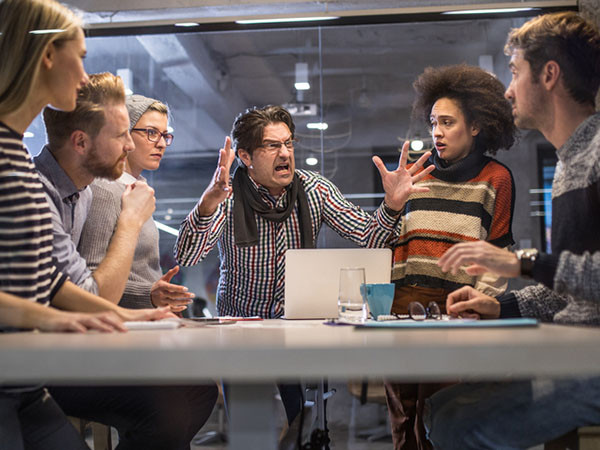 A man screaming, the group around him are staring at him, looking shocked