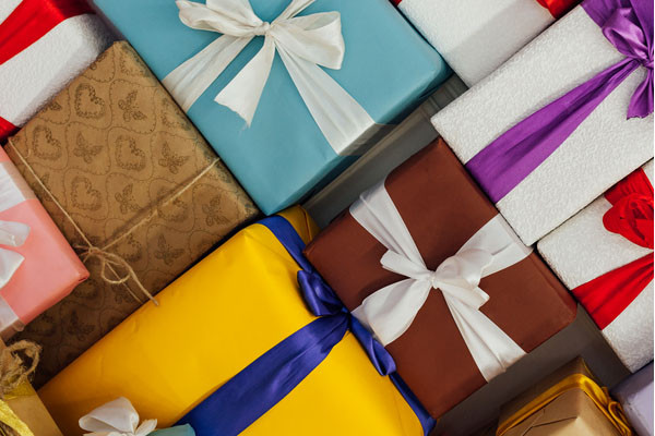 A collection of colorful presents wrapped in wrapping paper and a ribbon
