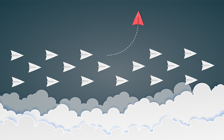 A graphic of a group of white paper planes flying horizontally above the clouds, one red paper plane flies vertically above the rest