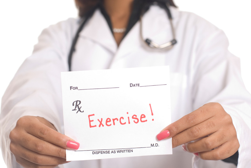 A doctor holding a prescription saying exercise