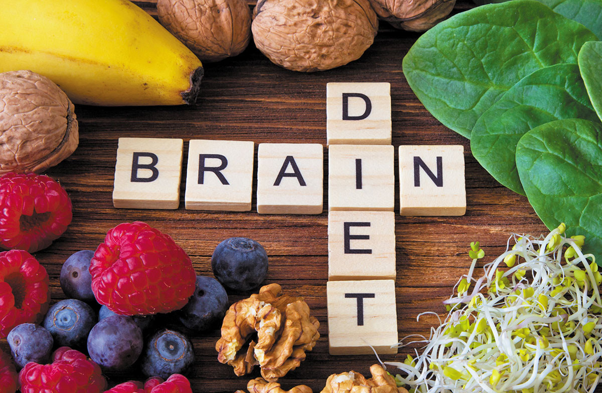 photo of word game letter tiles spelling out brain diet, and surrounded by healthy foods