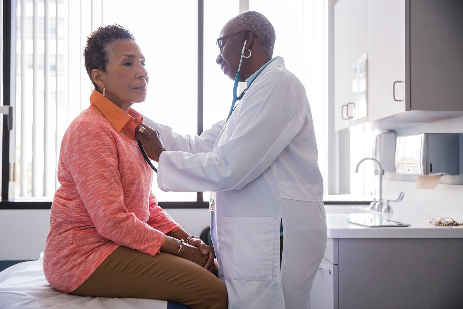 photo of a woman in a doctor's office having her heartbeat checked