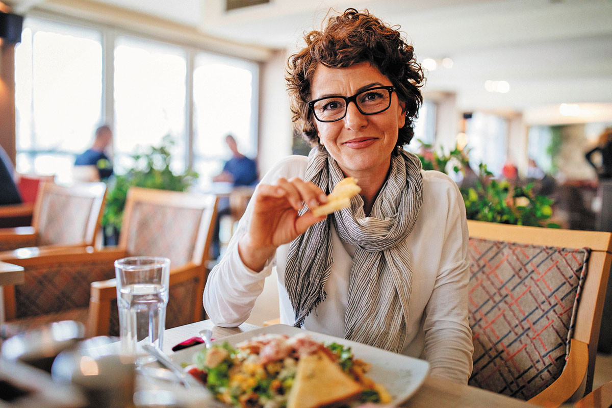photo of a woman enjoying a meal in a restaurant
