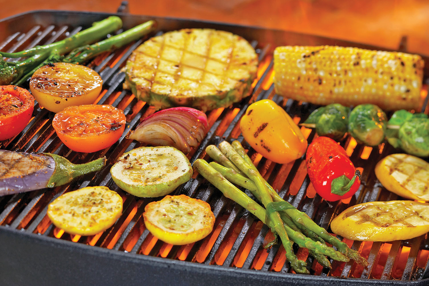 photo of assorted vegetables cooking on a grill