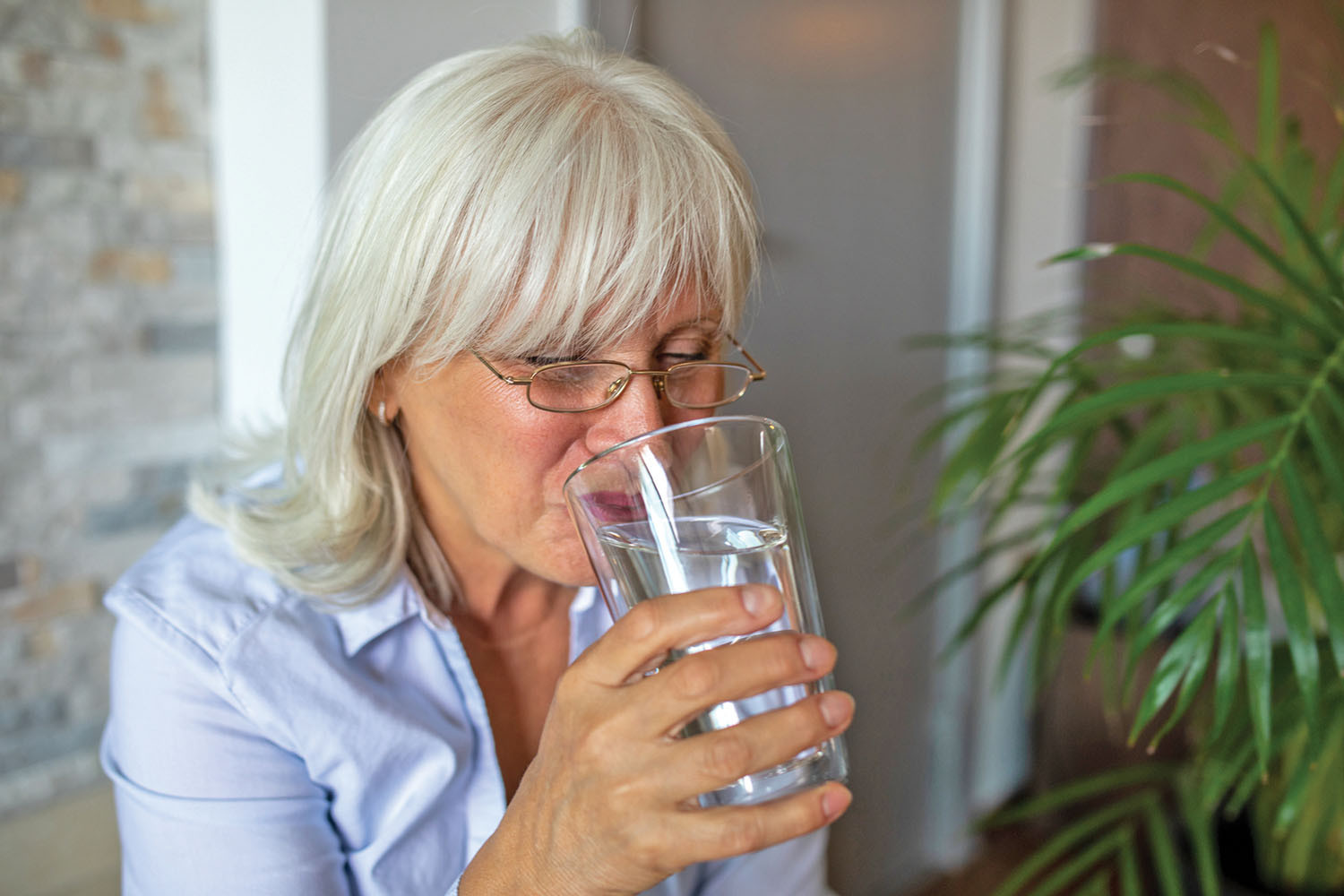 photo of a woman drinking a glass of water