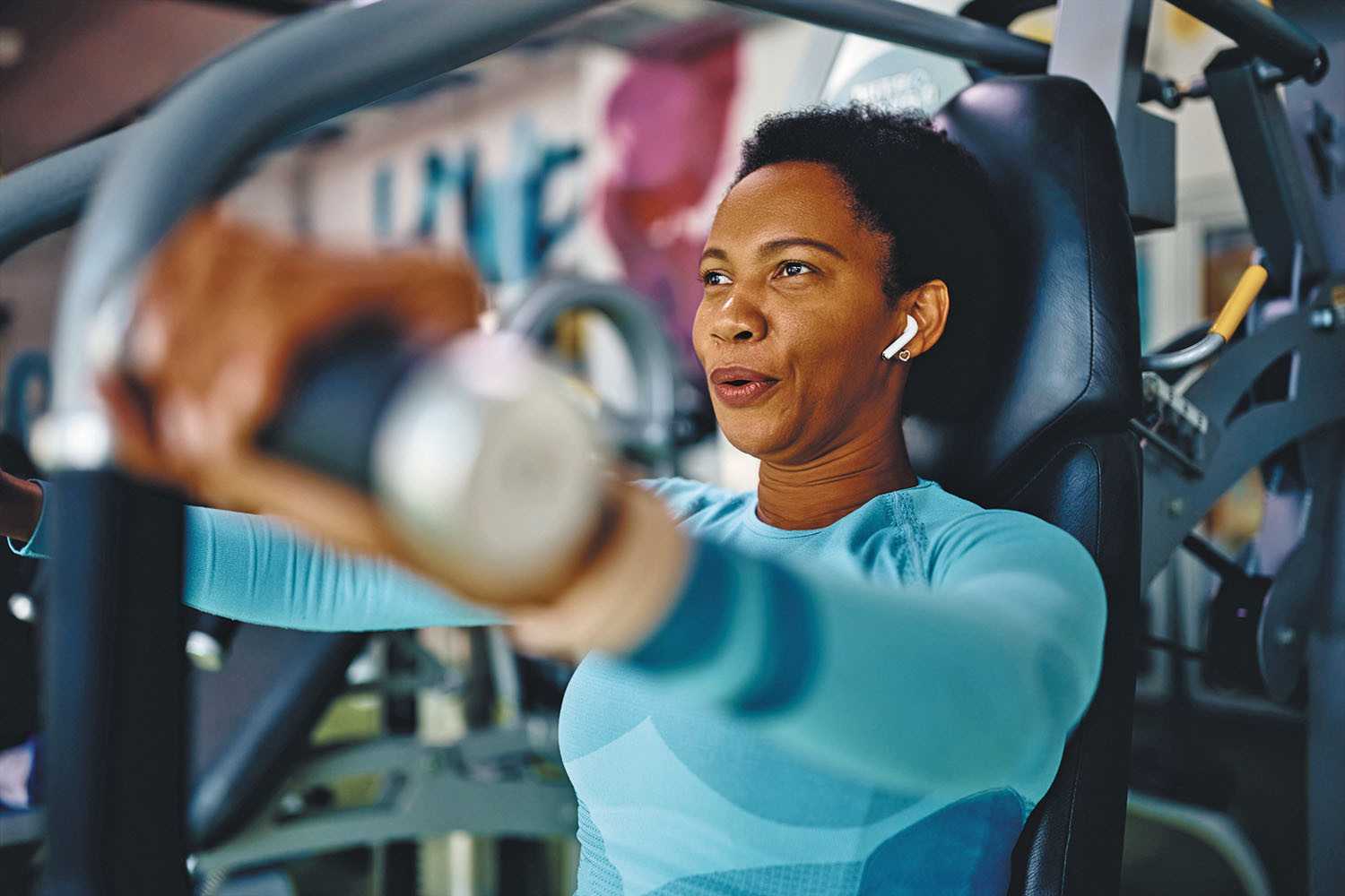 photo of a woman exercising in a gym using hand weights