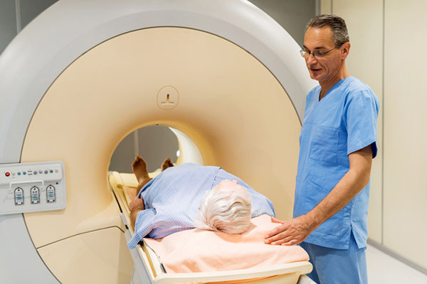 photo of a radiologist talking to a senior man about to have a scan for prostate cancer