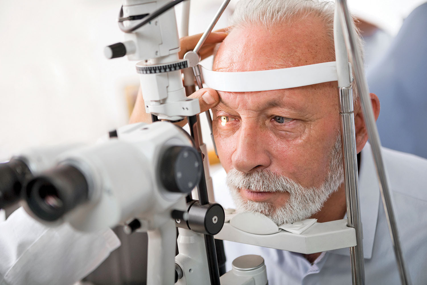photo of a mature man having his eye pressure checked during an eye exam