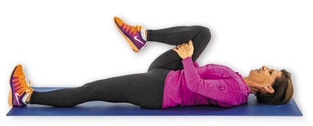 photo of a woman performing the single knee pull exercise as described in the article text