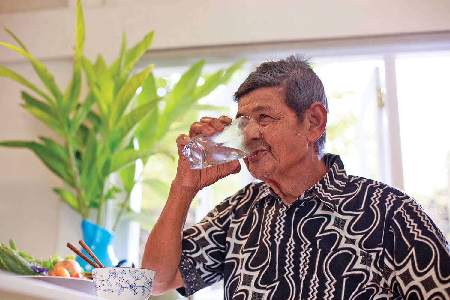 photo of a man drinking from a large glass of water