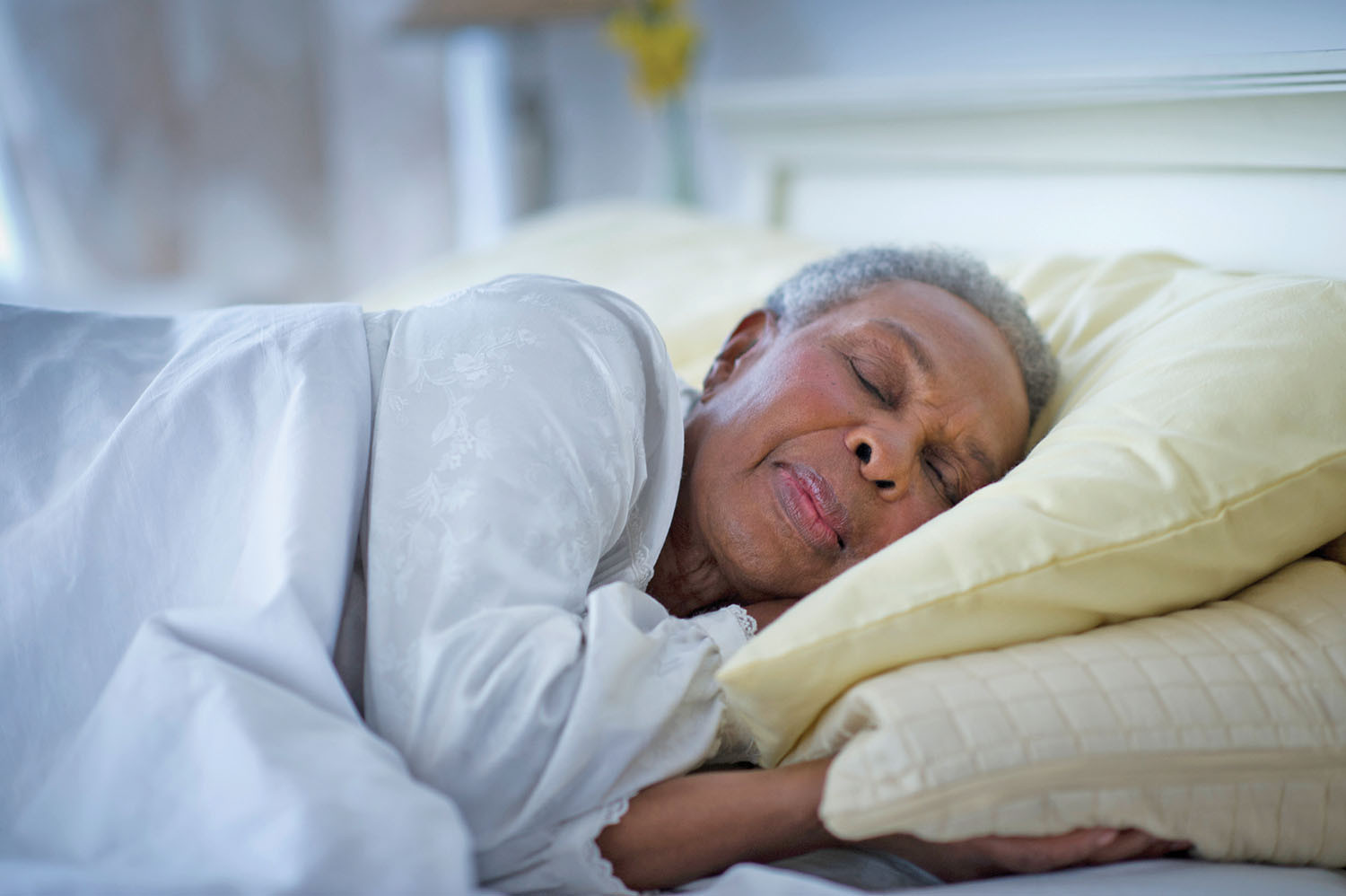 photo of a woman asleep on her left side