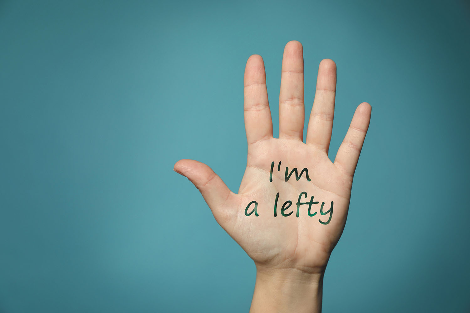 photo of a person's left hand with I'm a lefty written on the palm