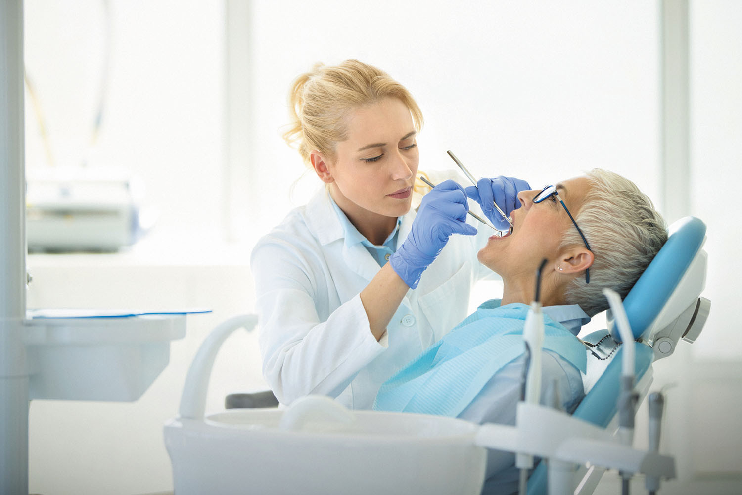 photo of a dental hygenist cleaning a patient's teeth