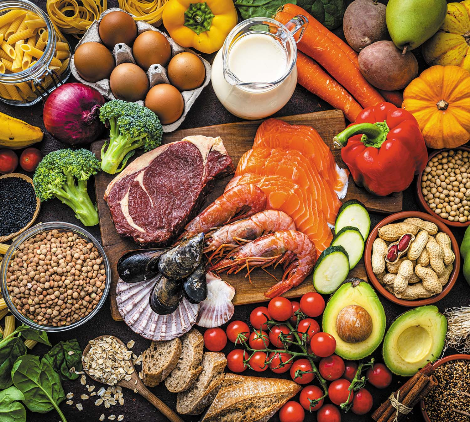 photo of an assortment of foods that are part of a healthy diet: fish, meat, vegetables, eggs, nuts