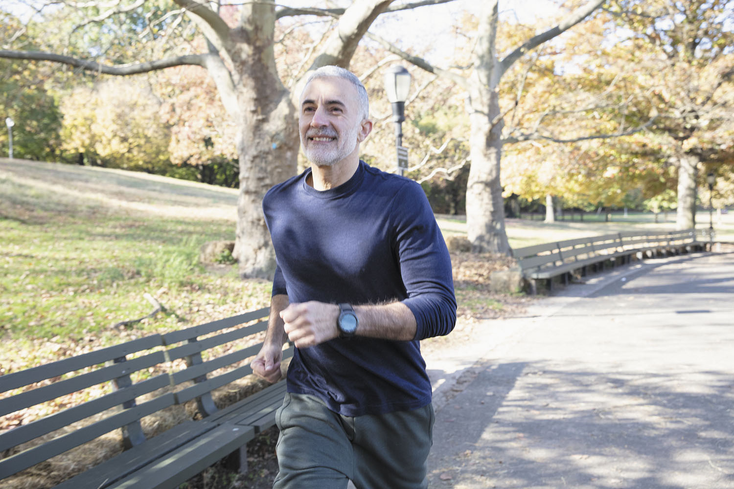 photo of a senior man jogging in a park