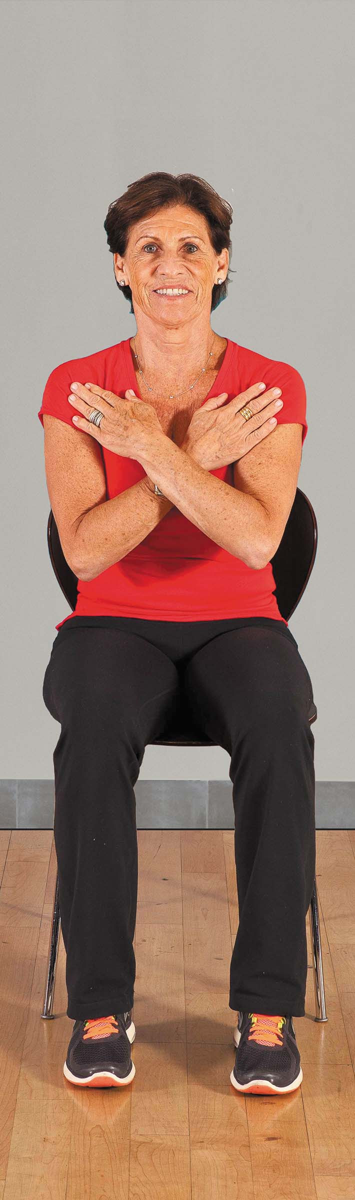 photo of a woman in the starting position for the sit to stand (no hands) exercise as described in the article