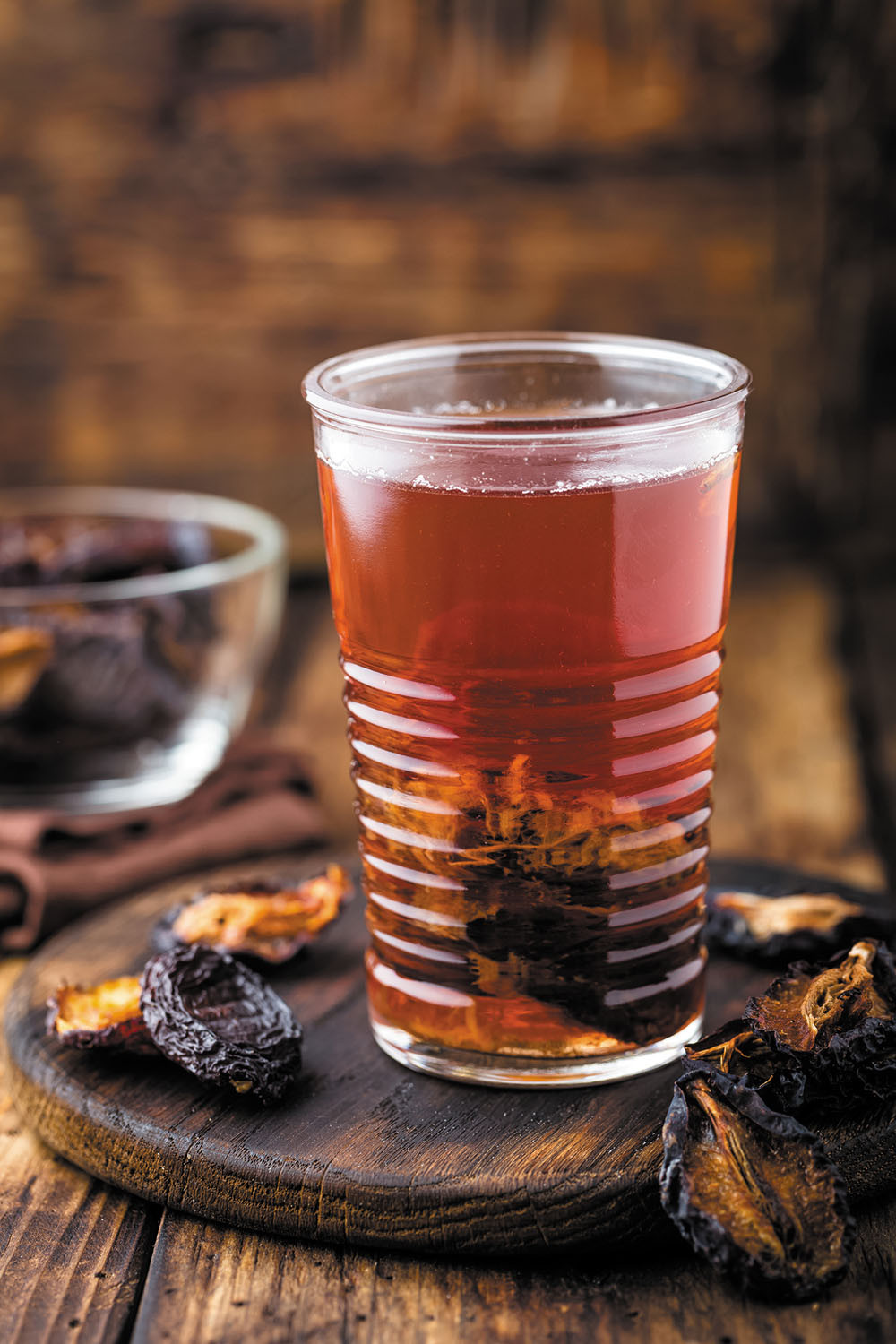 photo of a glass of prune juice on a wooden table