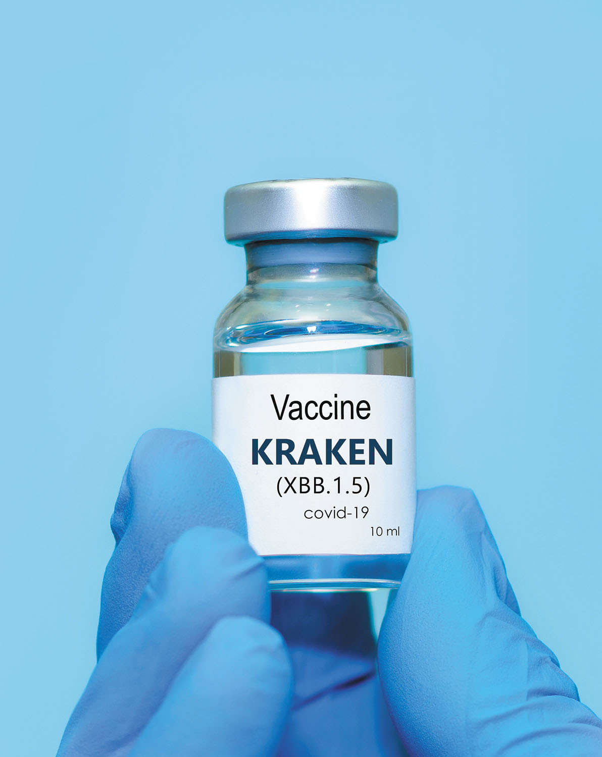 photo of a gloved hand holding a bottle containing vaccine for the COVID subvariant called Kraken