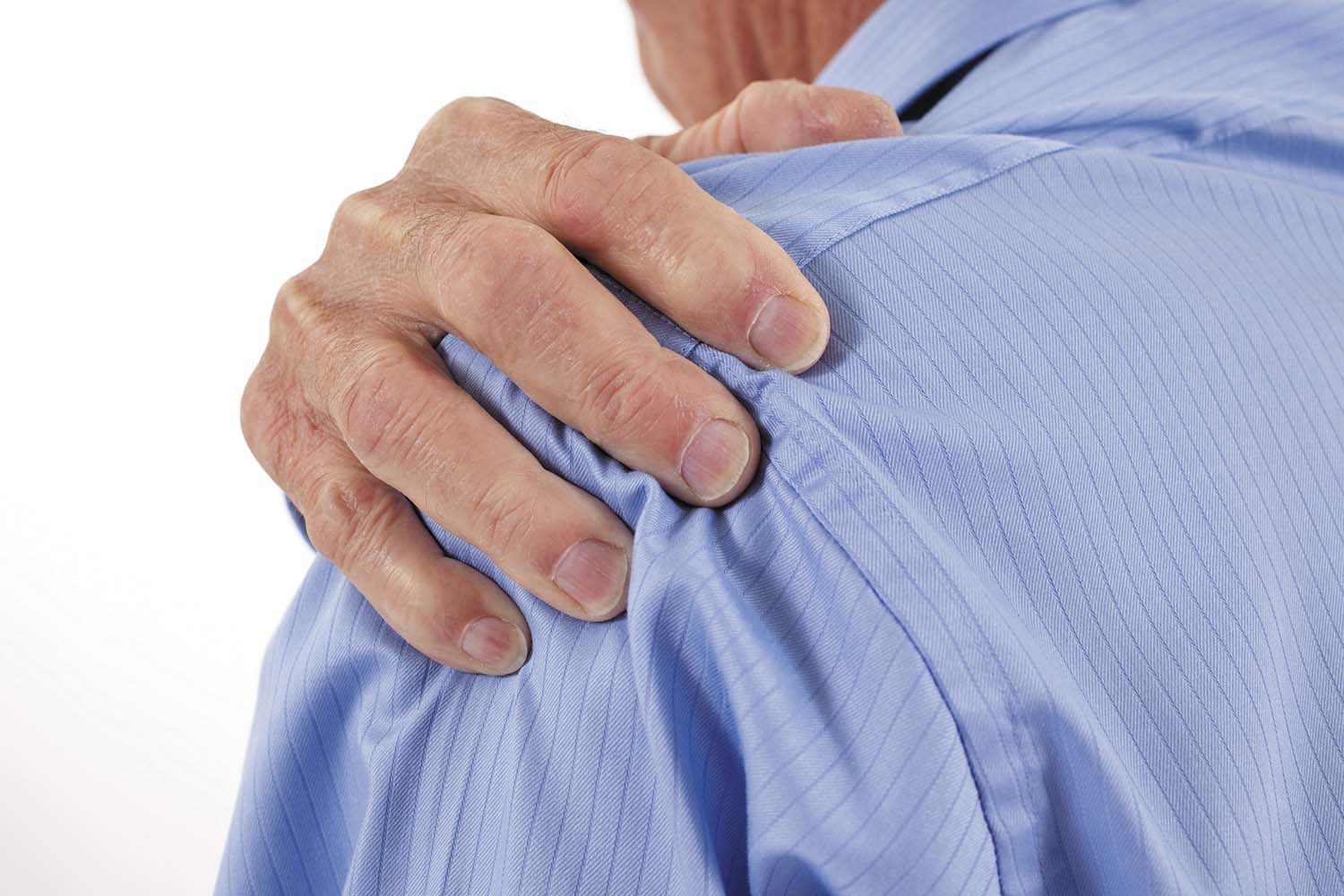 close-up photo of a man viewed from behind holding his hand on his sore shoulder