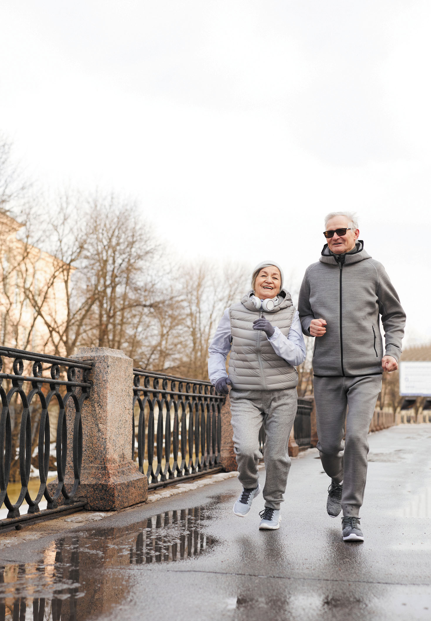photo of a woman and man walking for fitness; they are dressed for cold weather