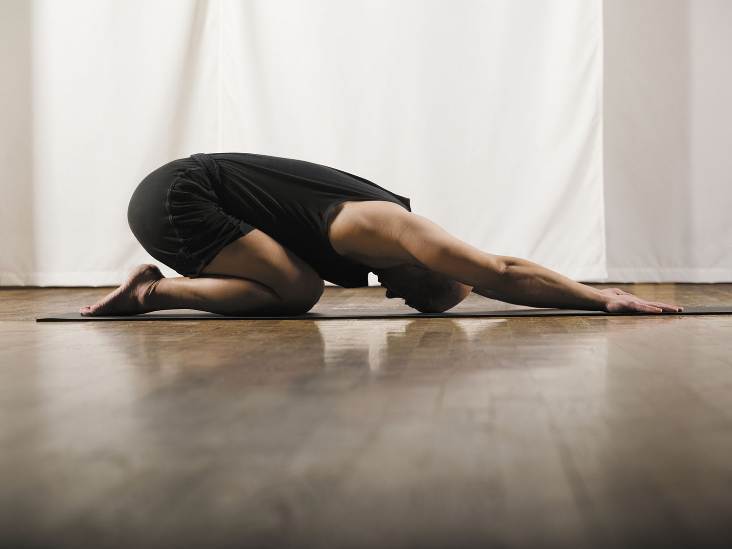 photo of a man in the yoga position called child's pose