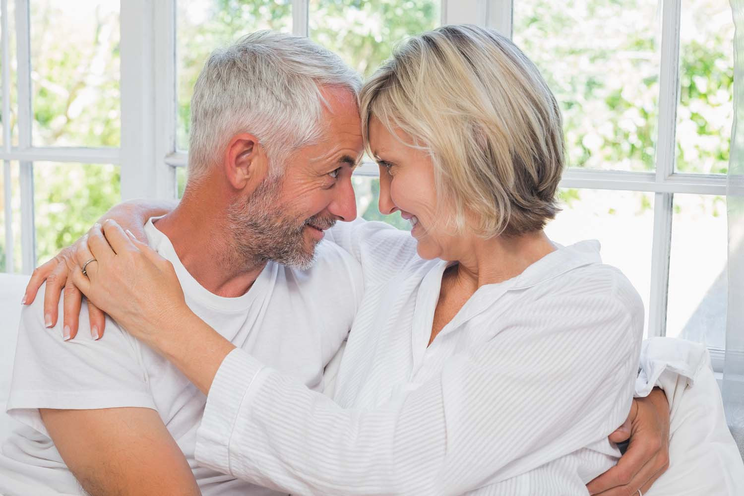 photo of a mature couple embracing and looking at each other, smiling