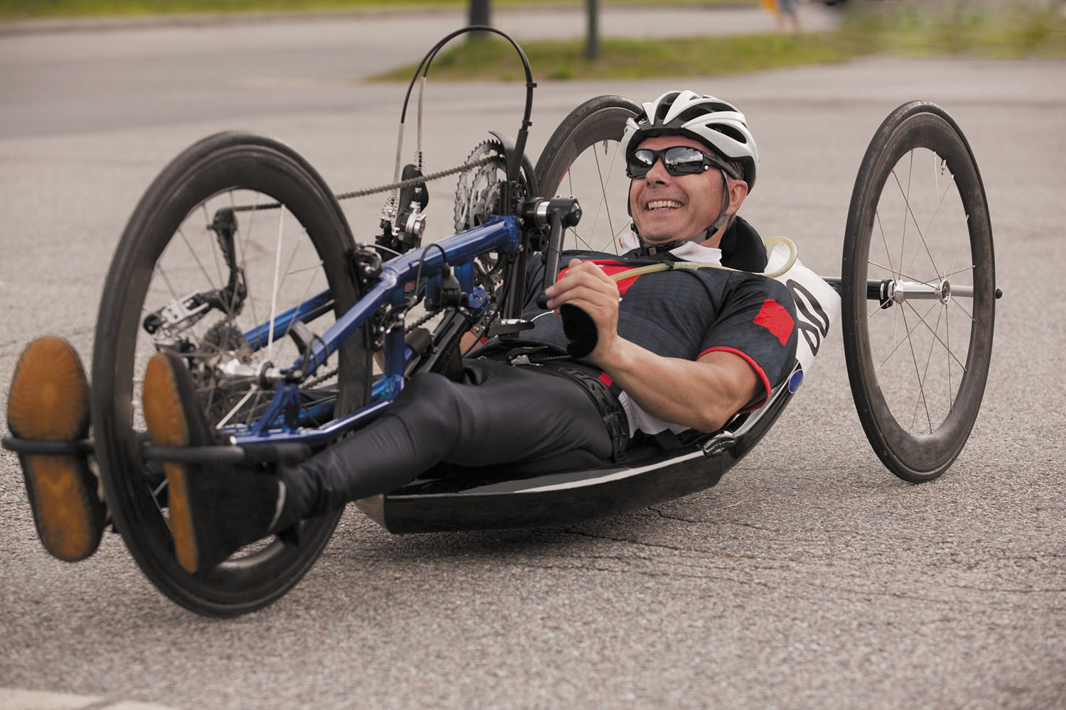 photo of a man riding a recumbent bicycle