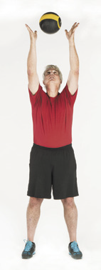photo of a man performing the squat and overhead toos exercise as described in the article