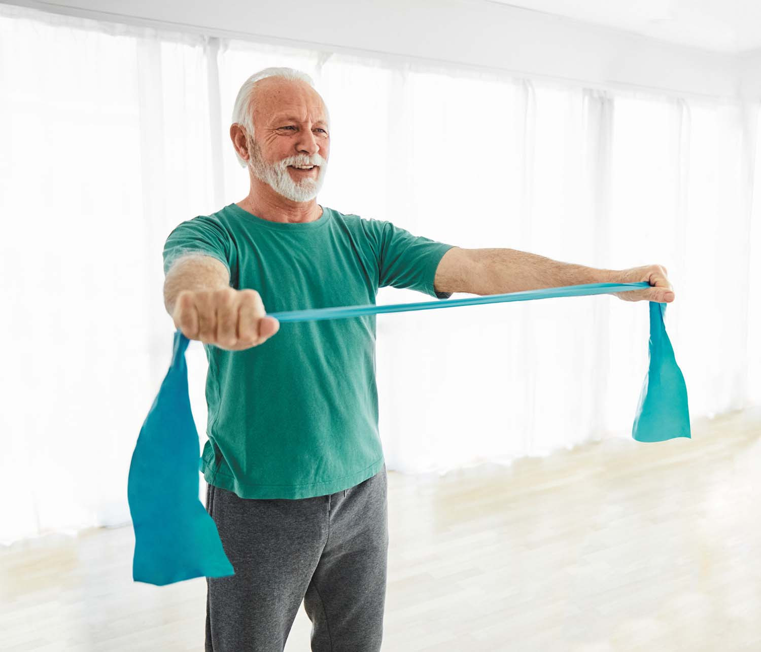 photo of a mature man exercising using a resistance band