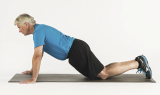 photo of a man in the starting position for the kneeling push-up exercise as described in the article