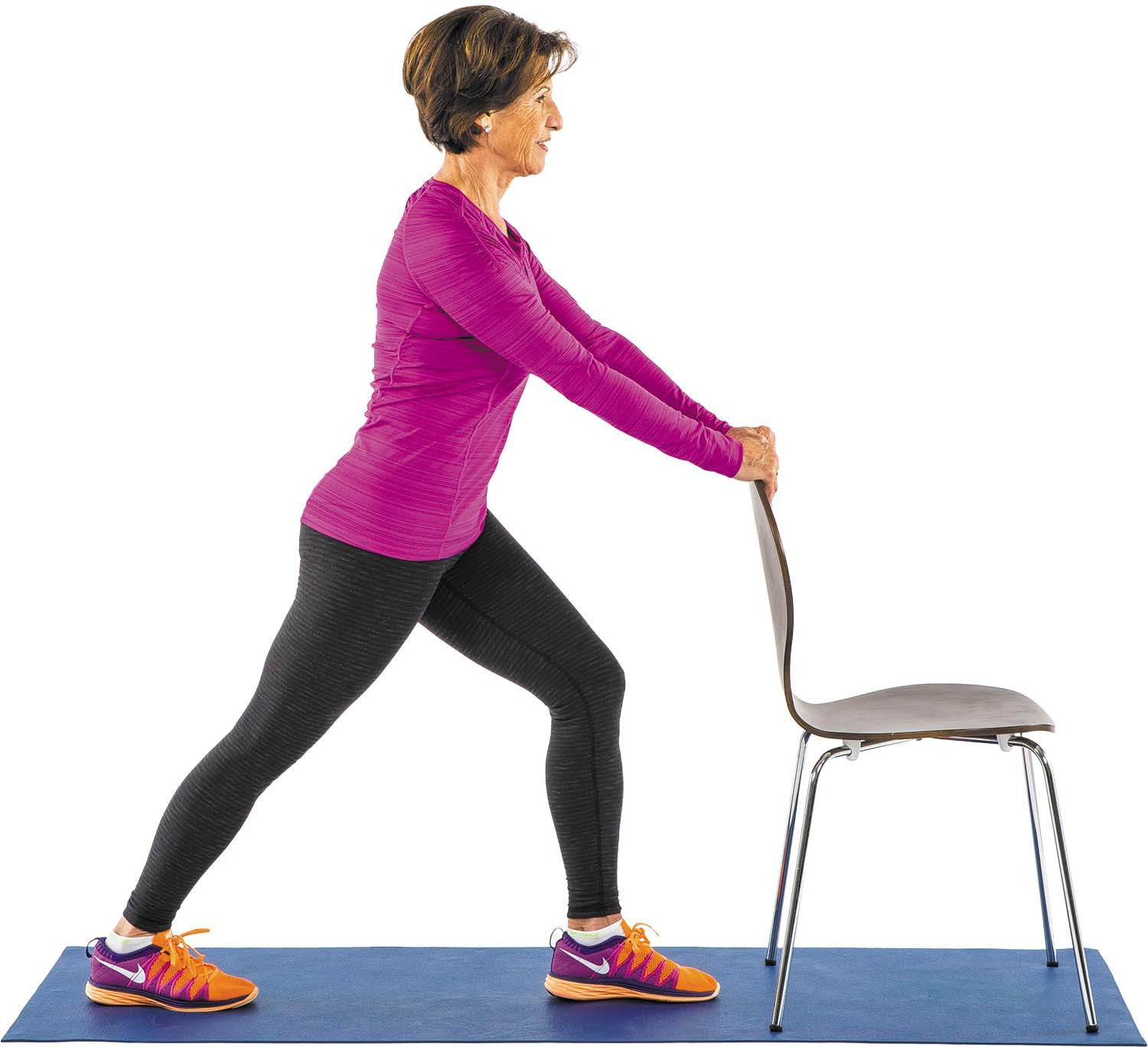 photo of a woman performing the calf stretch exercise as described in the article while holding the back of a chair