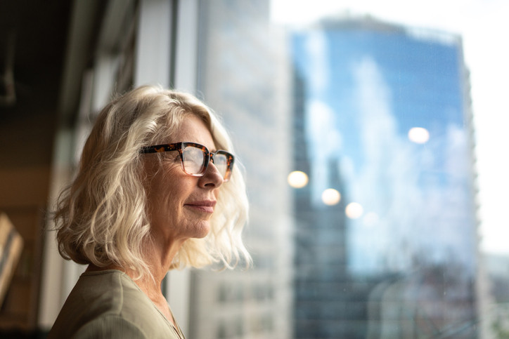 Mature businesswoman looking out of window