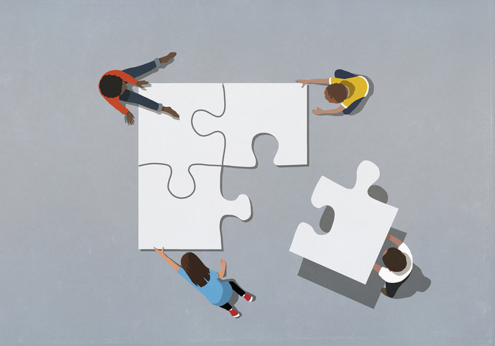Three children around three large, interlocked white puzzle pieces and a fourth bringing a large piece to finish the puzzle; background is gray